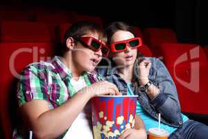 Young couple in cinema watching movie