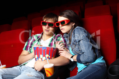 Young couple in cinema watching movie