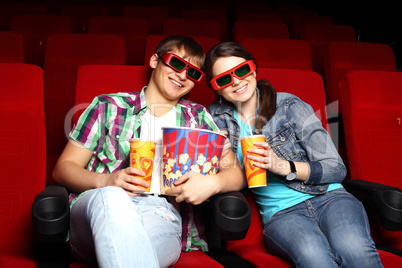 Young couple in cinema watching movie