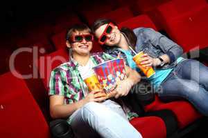 Young couple in cinema watching movie