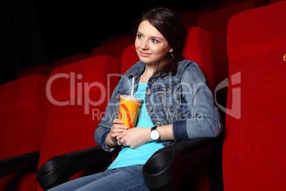 Young girl in cinema watching movie