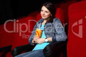 Young girl in cinema watching movie