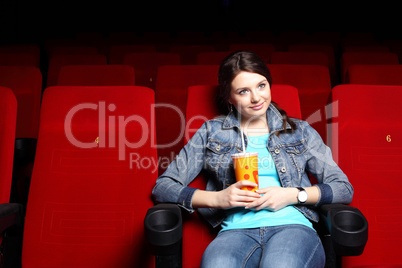 Young girl in cinema watching movie