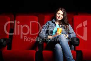 Young girl in cinema watching movie