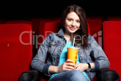 Young girl in cinema watching movie