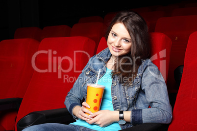 Young girl in cinema watching movie