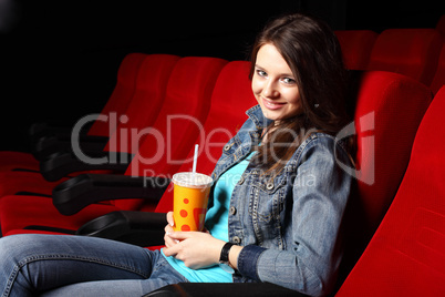 Young girl in cinema watching movie