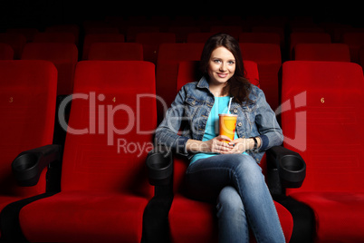 Young girl in cinema watching movie