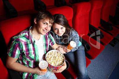 Young couple in cinema watching movie