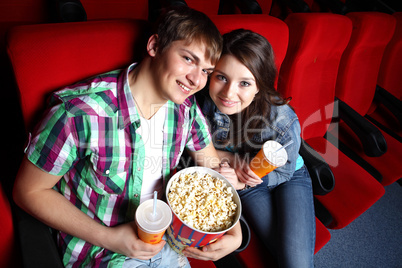 Young couple in cinema watching movie