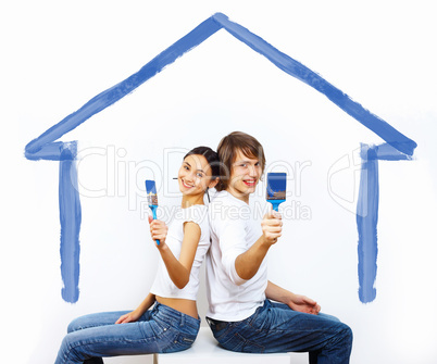 Young couple with paint brushes together