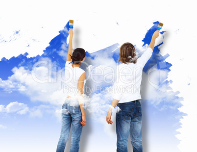 Young couple with paint brushes together