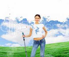 Young woman with paint brush and natural landscape