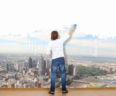 Young man with paint brush and nature landscape