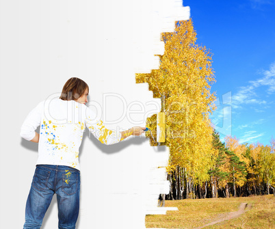 Young man with paint brush and nature landscape