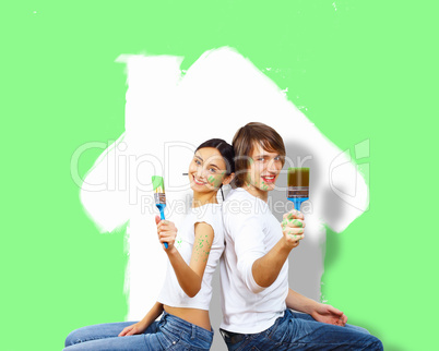 Young couple with paint brushes together