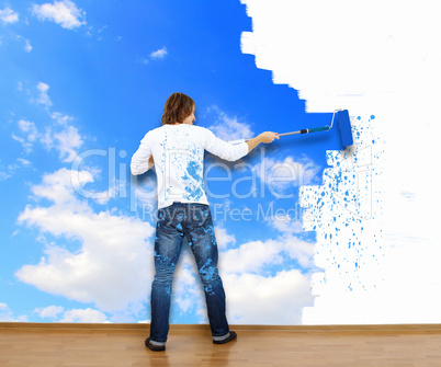 Young man with paint brush and nature landscape