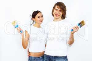 Young couple with paint brushes together