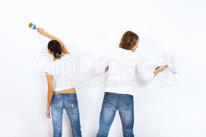 Young couple with paint brushes together