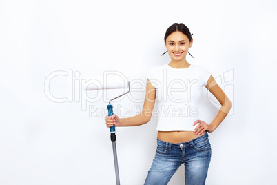 Young woman with paint brushes