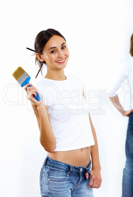 Young woman with paint brushes