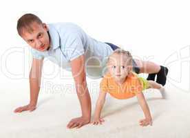 father and little daughter doing sport