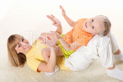 mother and little daughter doing sport together