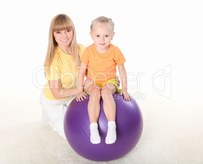 mother and little daughter doing sport together