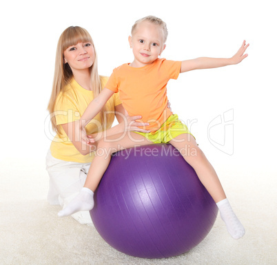 mother and little daughter doing sport together