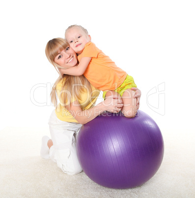 mother and little daughter doing sport together