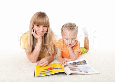 young mother reading a book to his daughter