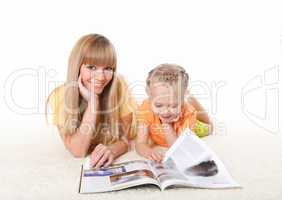young mother reading a book to his daughter