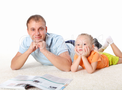 young father reading a book to his daughter
