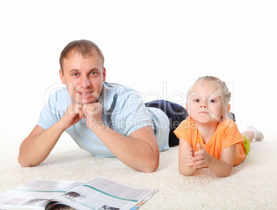 young father reading a book to his daughter