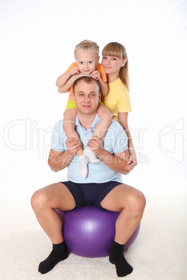 family with a little daughter doing sport together