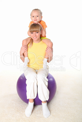 mother and little daughter doing sport together