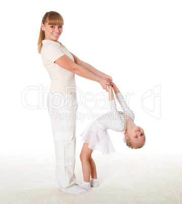 mother and little daughter doing sport together