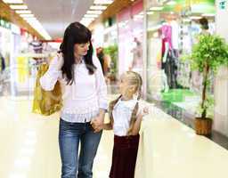 Young mother and her daughter doing shopping