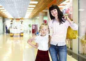 Young mother and her daughter doing shopping