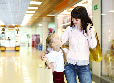 Young mother and her daughter doing shopping