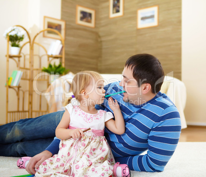 father with his little daughter at home