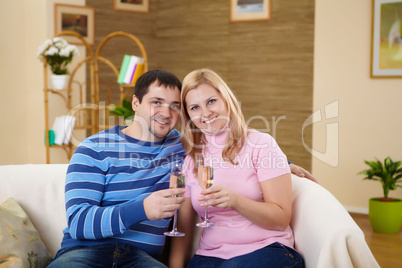 couple with glasses of champagne at home