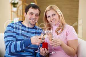 couple with glasses of champagne at home