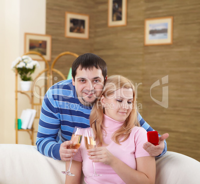 couple with glasses of champagne at home