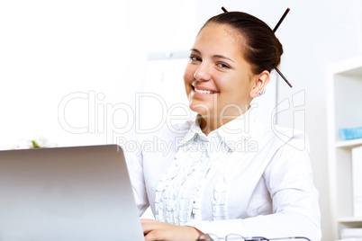 Young beautiful woman in business wear at work