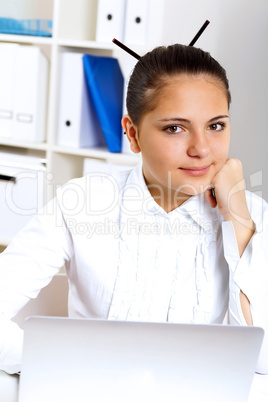 Young beautiful woman in business wear at work