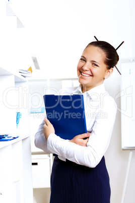 Young beautiful woman in business wear at work