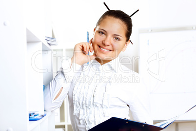 Young beautiful woman in business wear at work