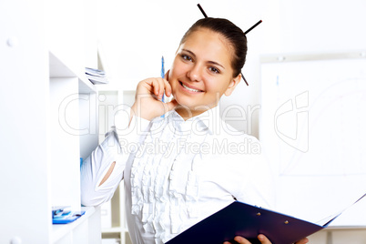 Young beautiful woman in business wear at work