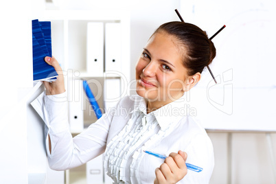 Young beautiful woman in business wear at work